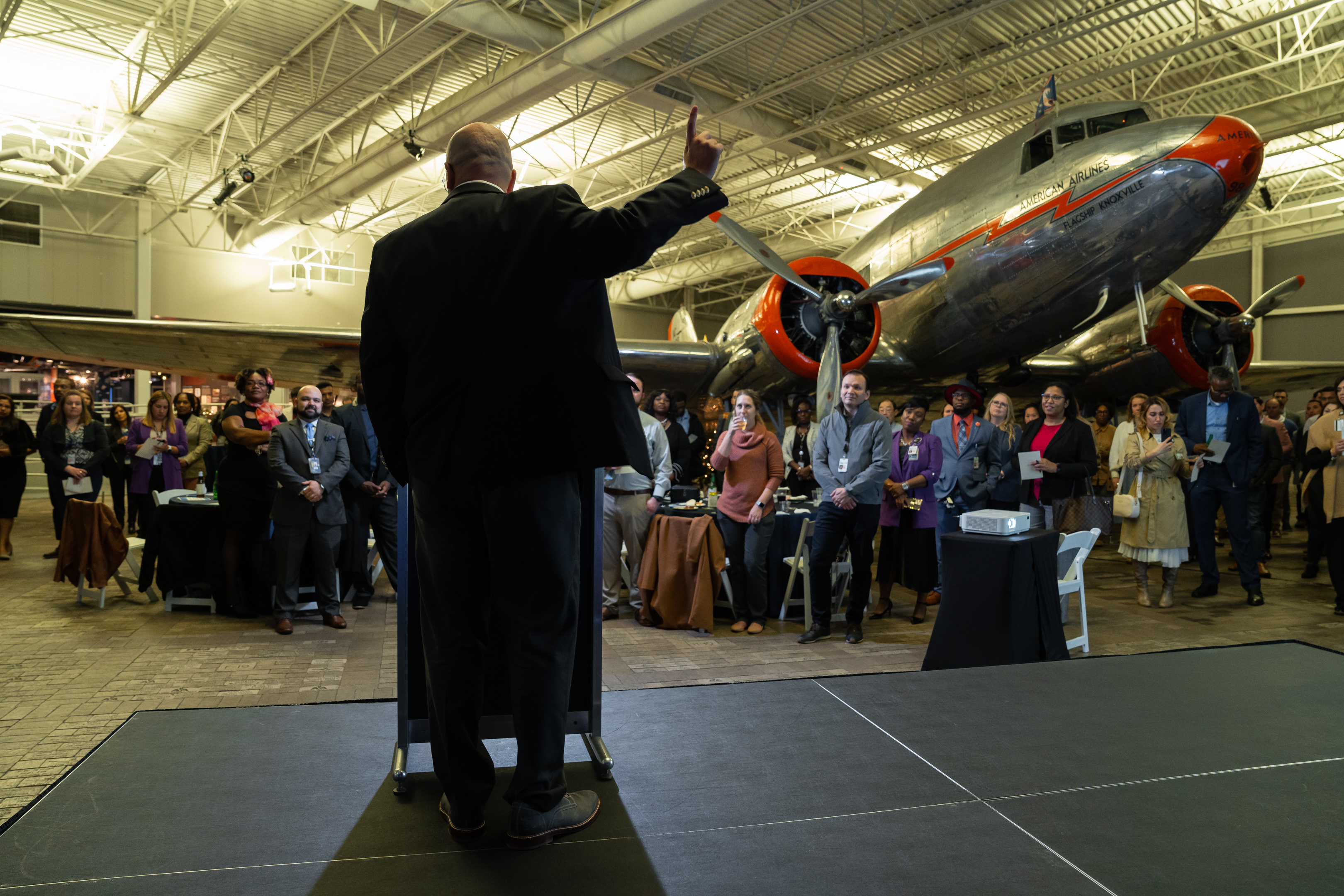 Dr. Robert Hausmann addressing a leadership audience at an American Airlines event